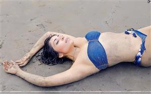 Bikini-clad Farrah Kader - wallowing in sand